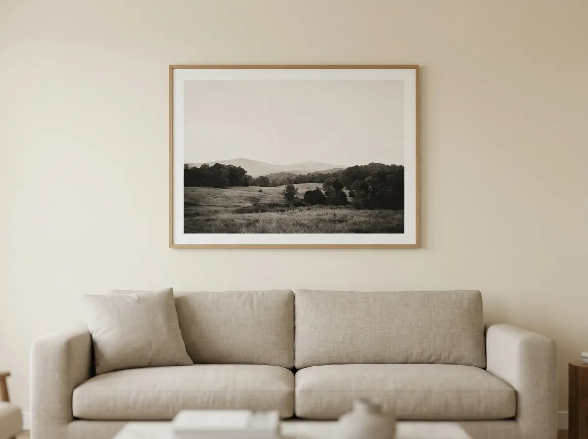 A large-format muted landscape print used as modern wall art for any interior above a neutral sofa